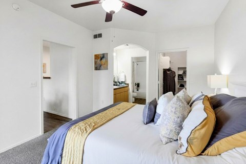 Master bedroom with vaulted ceiling and ensuite bathroom at Ventura Vista Apartments, Phoenix, AZ
