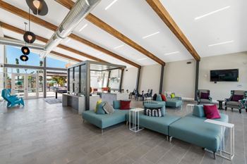 a lobby with blue couches and colorful pillows at Melody on Main, Mesa, AZ