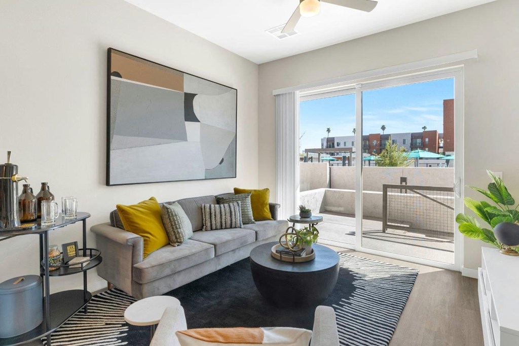a living room with a large window and a sliding glass door at Melody on Main, Arizona