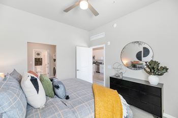 a bedroom with a bed and a dresser with a mirror at Melody on Main, Arizona