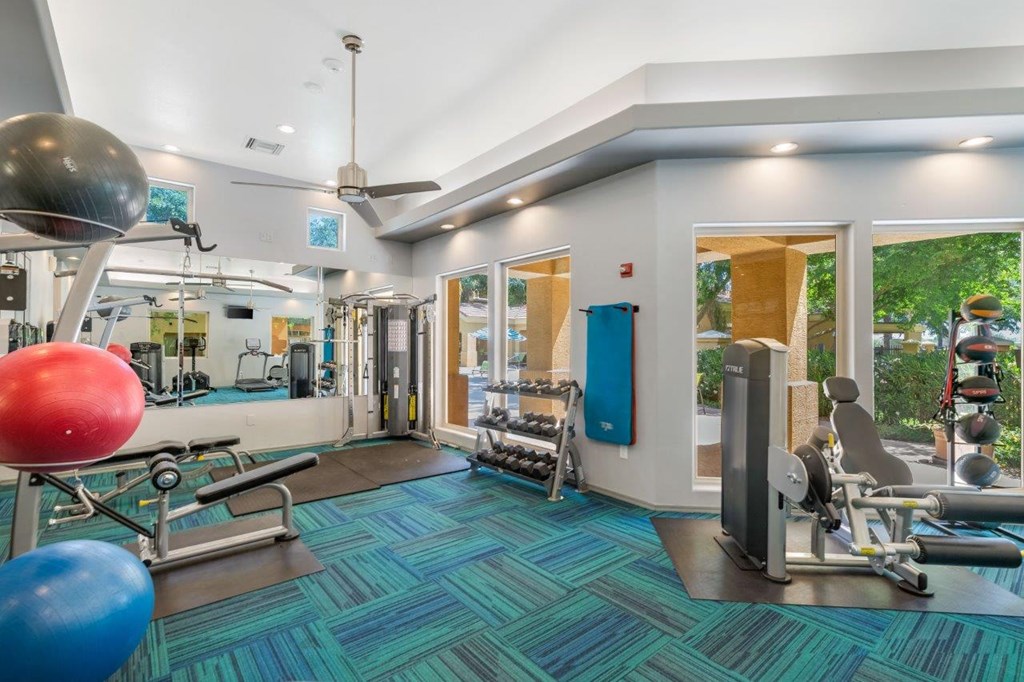 a gym with weights and cardio equipment at the estates apartments