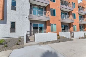 an exterior view of an apartment building with stairs and balconies