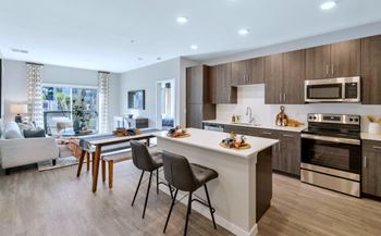 a kitchen with a large island with a breakfast bar and a living room with a couch at Glen 91, Arizona, 85305