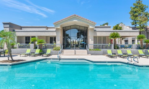 A large house with a pool in front.