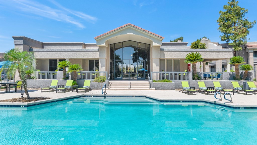 A large house with a pool in front.