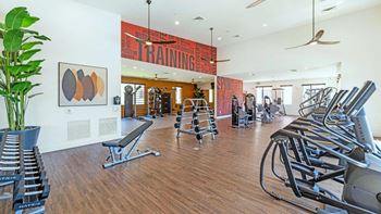 a gym with cardio equipment and a large painting on the wall at Hangar at Thunderbird, Glendale