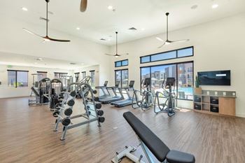 the home has a gym with a treadmill and elliptical machines at Hangar at Thunderbird, Glendale, AZ