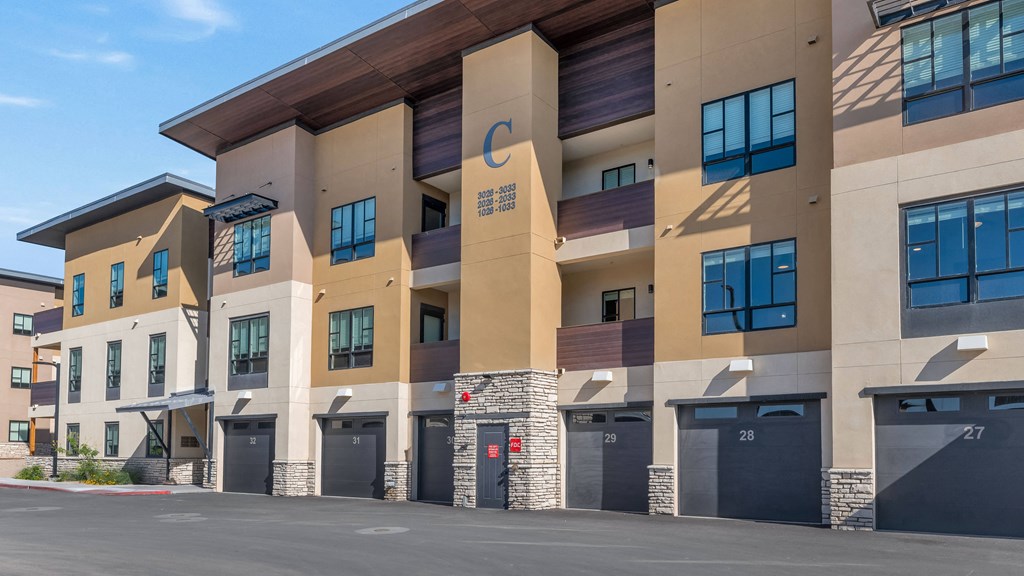 a building with many windows and a street in front of it