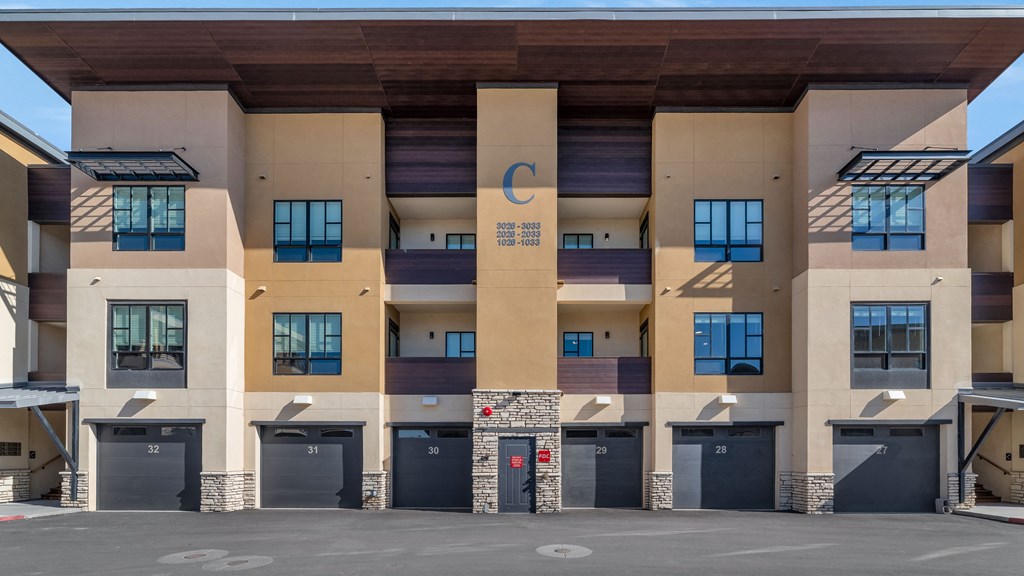 a building with a c on it and a parking lot