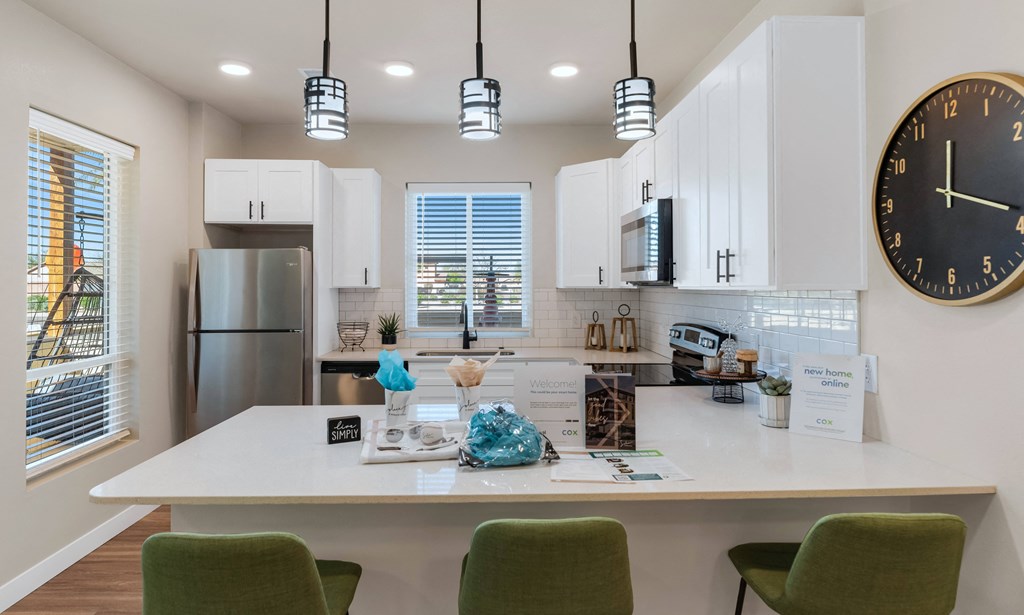 a kitchen with a quartz counter top and a large clock