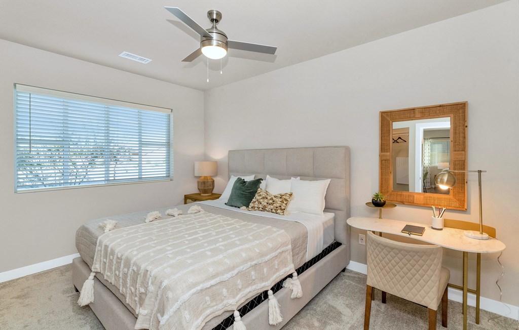 a bedroom with a bed and a ceiling fan
