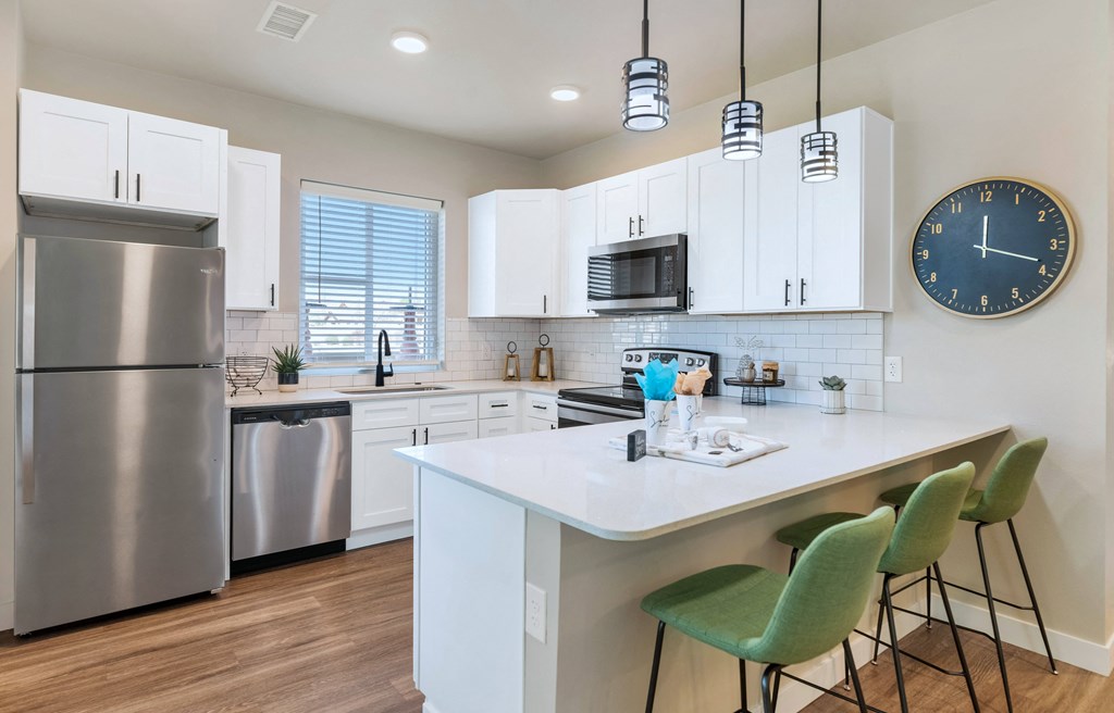 a kitchen with stainless steel appliances and a quartz counter top