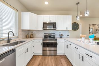 Kitchen With White Cabinetry And Appliances at Solace at Ballpark Village, Arizona