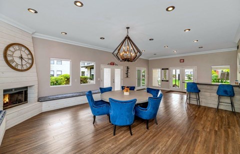 a dining room with a table and chairs and a fireplace