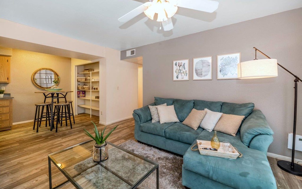 a living room with a couch and a ceiling fan