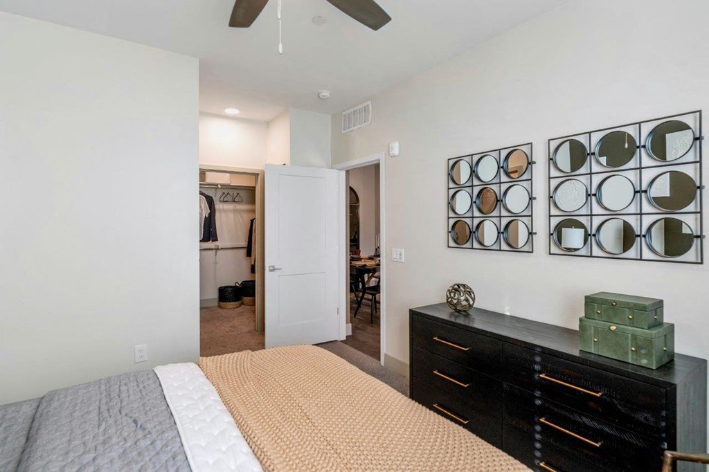 Bedroom with bed, cupboard and wall designed frames at Zaterra Luxury Apartments, Chandler, 85286