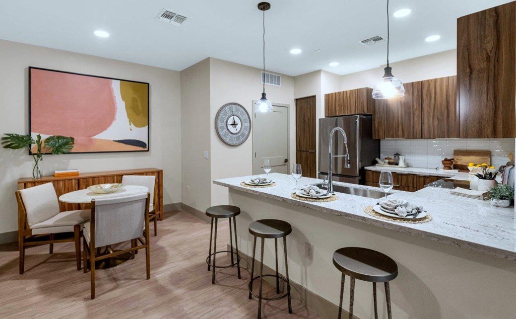 Kitchen with appliances and dining area at Zaterra Luxury Apartments, Chandler, Arizona