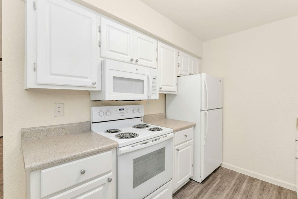 a kitchen with white appliances and white cabinets