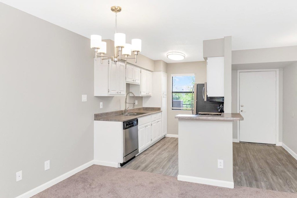 a kitchen and living room with a chandelier