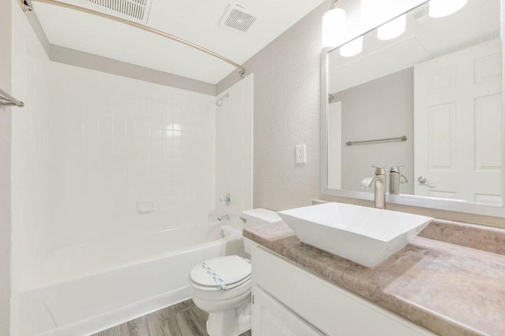 a bathroom with a sink toilet and bathtub