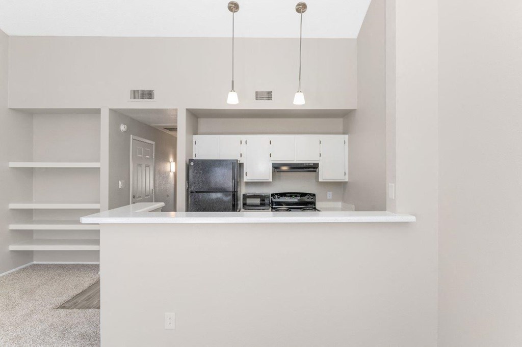a kitchen with a counter top and a refrigerator