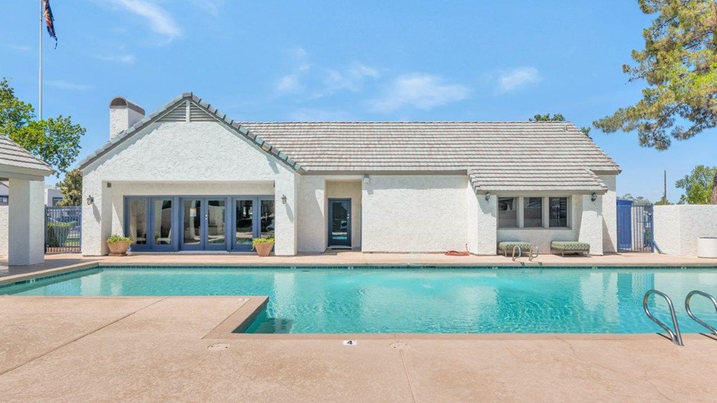 a house with a swimming pool in front of it