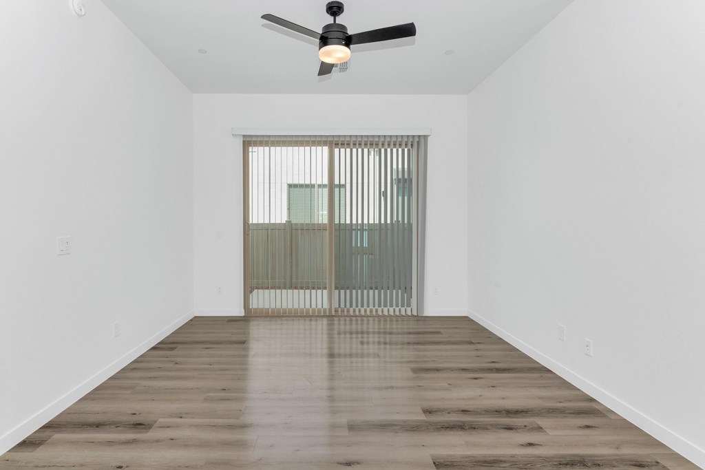 A room with a ceiling fan and a window with blinds at Marketside Villas at Verrado, Buckeye, AZ