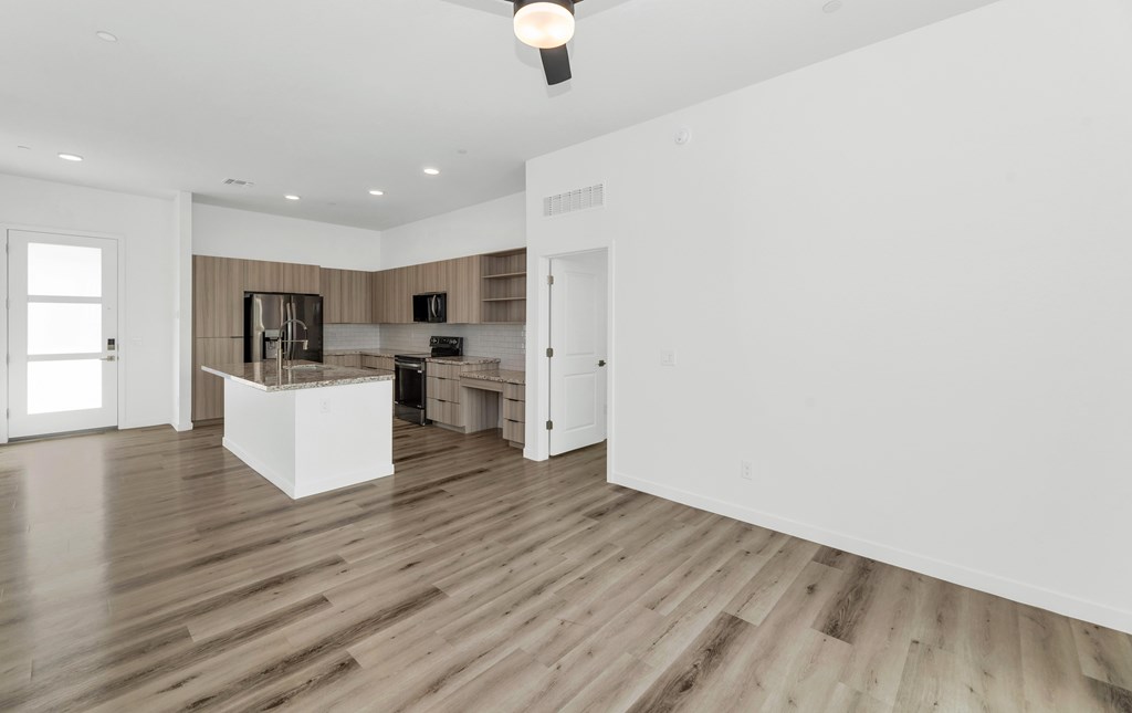 A kitchen with a white island in the middle of the room at Marketside Villas at Verrado, Buckeye, AZ