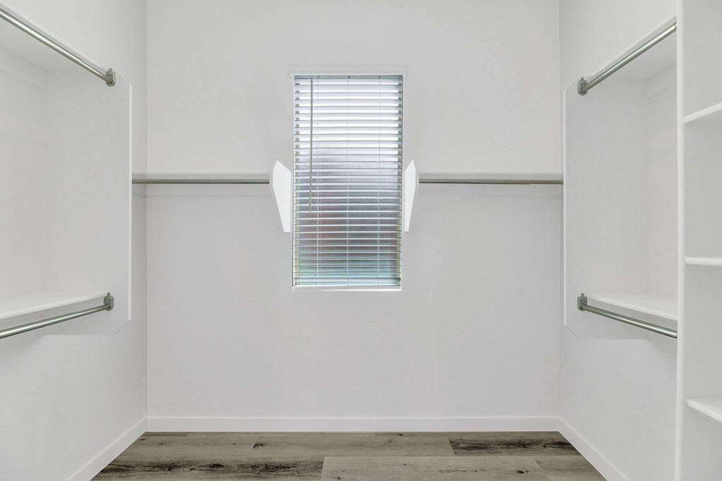 A white room with a window and a wooden floor at Marketside Villas at Verrado, Buckeye, AZ