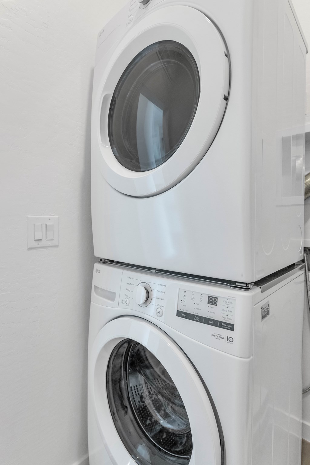 A white washing machine and dryer stacked on top of each other at Marketside Villas at Verrado, Buckeye, AZ