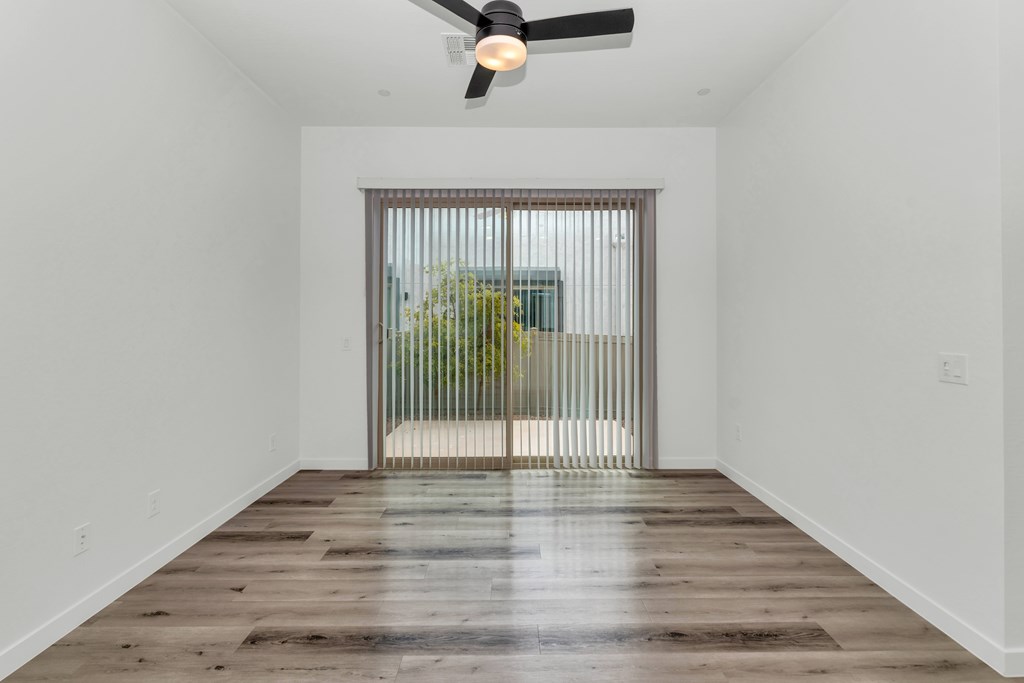 A room with a sliding door and a ceiling fan at Marketside Villas at Verrado, Buckeye, AZ