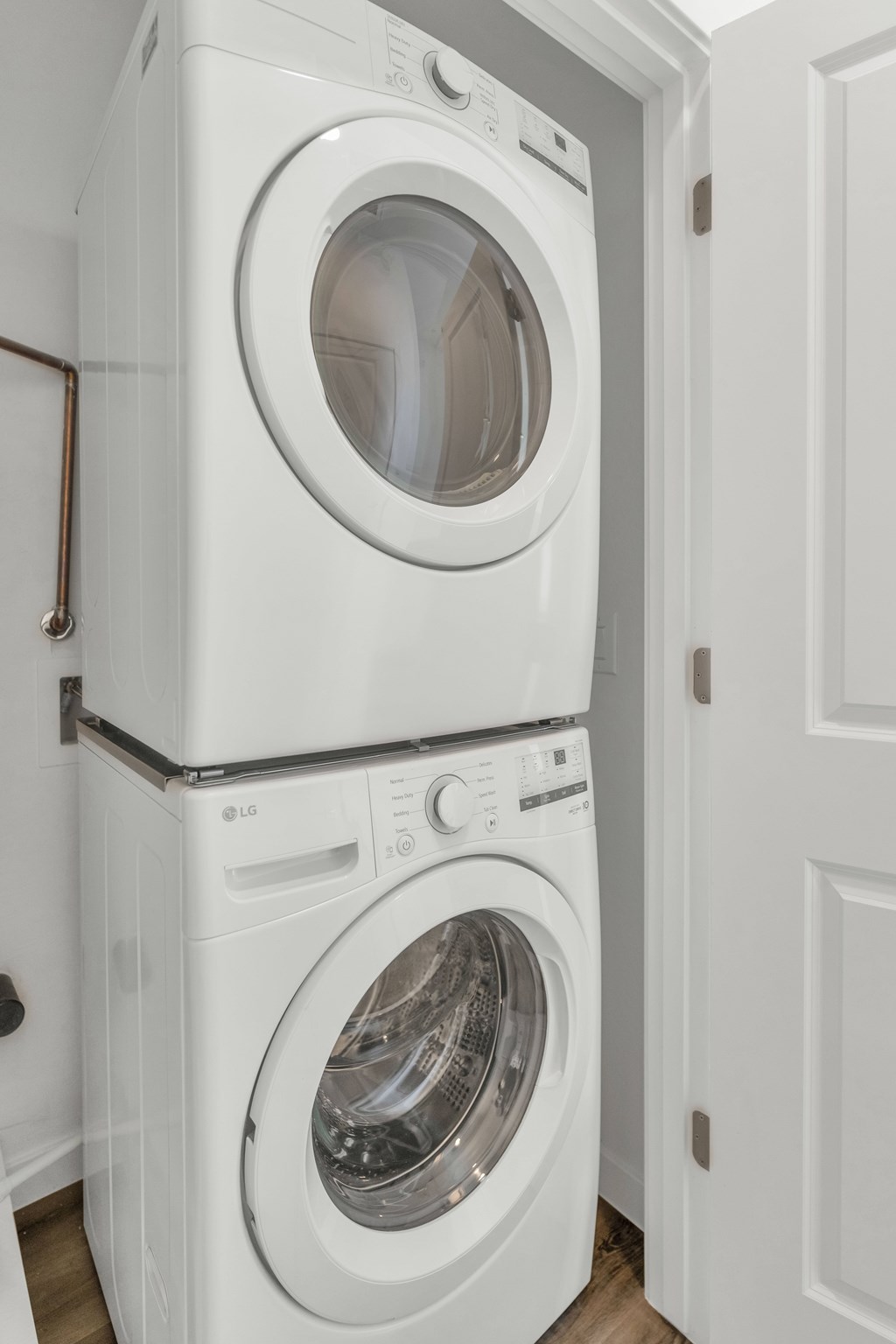 A white washing machine is stacked on top of another white washing machine at Marketside Villas at Verrado, Buckeye, AZ