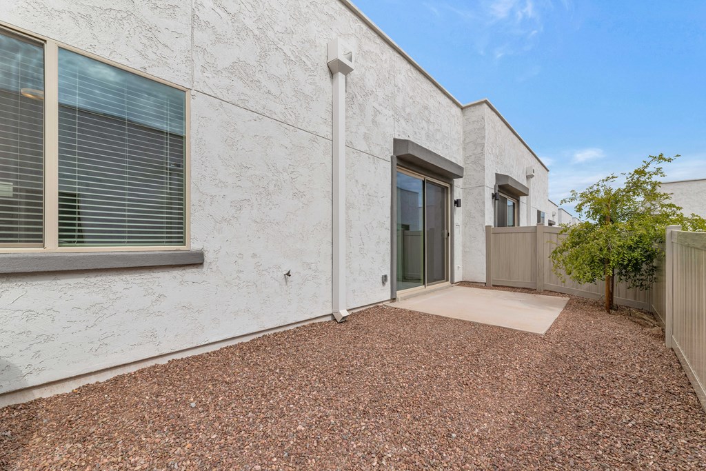 A white building with a brown gravel area in front at Marketside Villas at Verrado, Buckeye, AZ