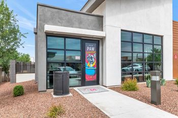 A building with a large window and a sign that says "PAW" on it.