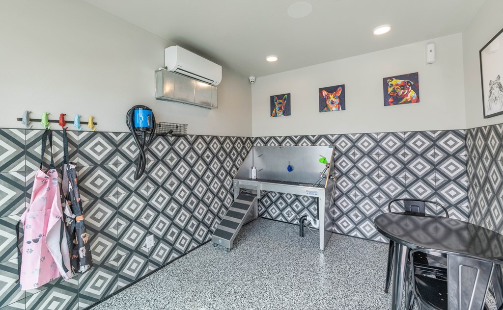 A room with a patterned wallpaper and a table with chairs at Marketside Villas at Verrado, Buckeye, AZ
