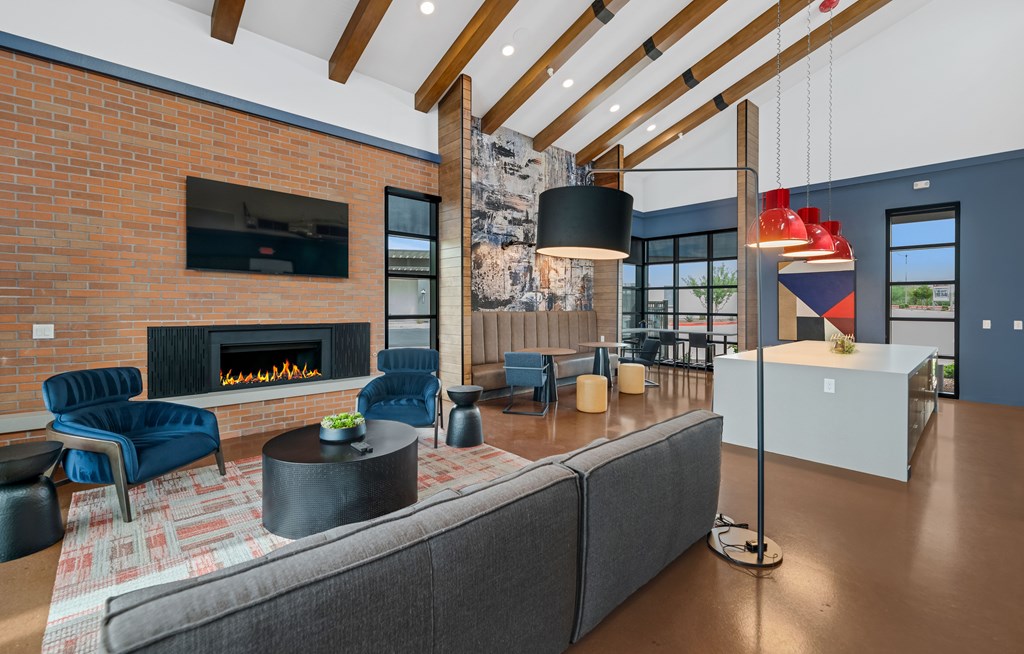 A modern living room with a fireplace and a grey sofa at Marketside Villas at Verrado, Buckeye, AZ