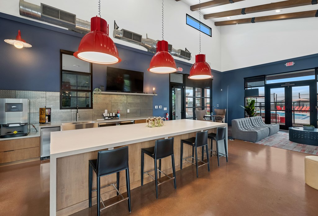 A modern kitchen with a bar area and seating at Marketside Villas at Verrado, Buckeye, AZ