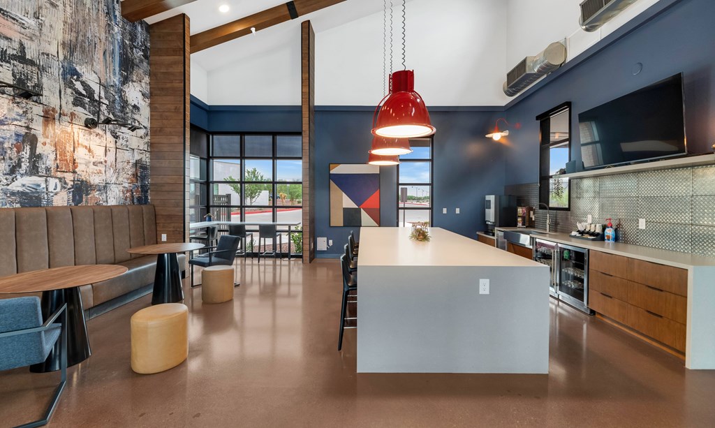 A modern kitchen with a dining area and a large painting on the wall at Marketside Villas at Verrado, Buckeye, AZ