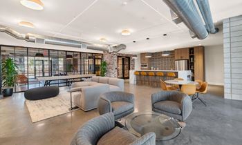 a lobby with couches and chairs and a bar at The Common Apartments, Phoenix