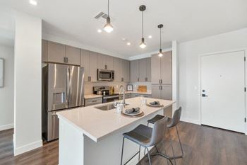 Kitchen with a large island and stainless steel appliances at The Common Apartments, Phoenix, Arizona, AZ