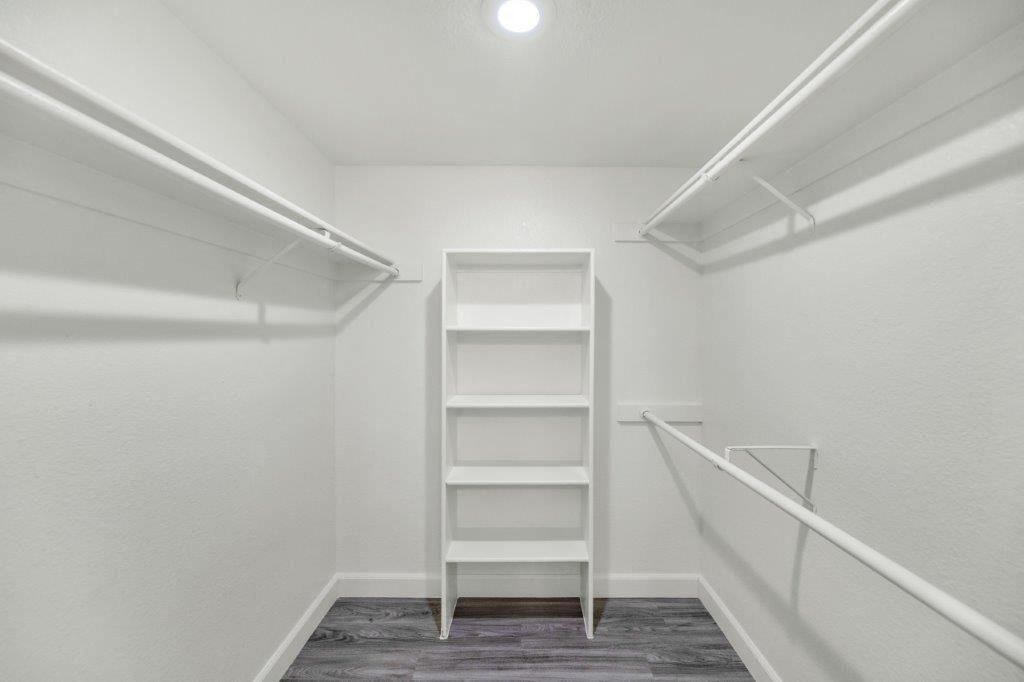a white closet with a ladder in the corner of a room
