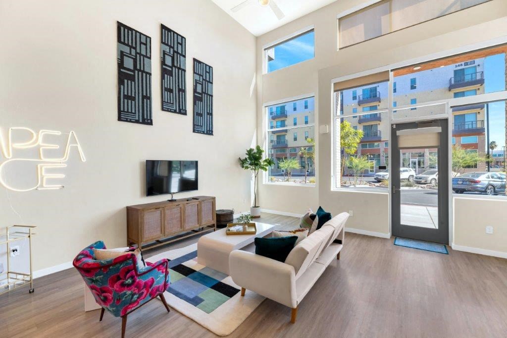 a living room with a couch and a tv in front of a window