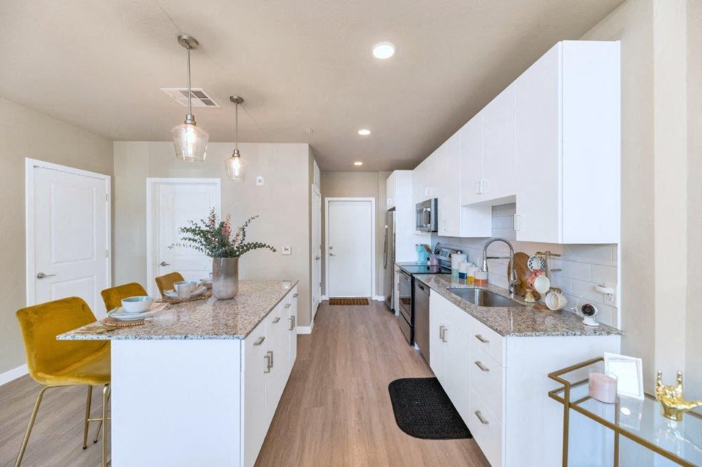 a kitchen with white cabinets and a counter top