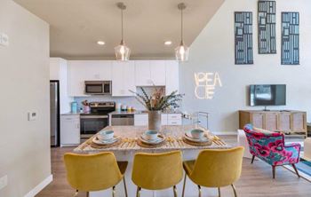 a kitchen and dining room with a table and chairs