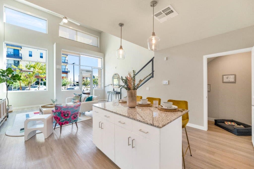 a kitchen with a counter top and a living room