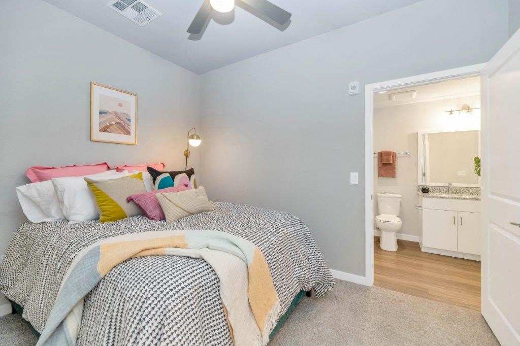 a bedroom with a bed and a bathroom with a toilet