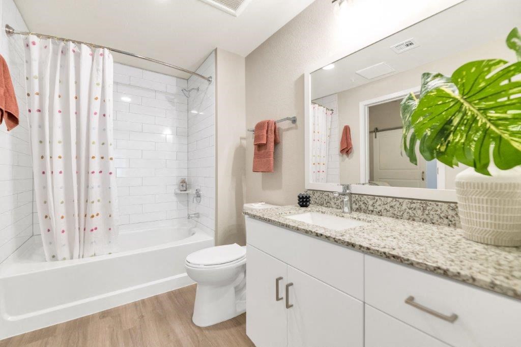 a bathroom with a toilet and a shower and a sink