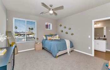 a bedroom with a bed and a ceiling fan