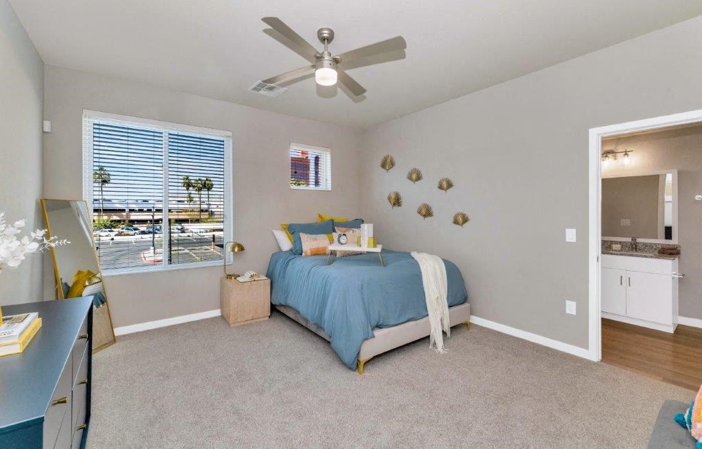 a bedroom with a bed and a ceiling fan