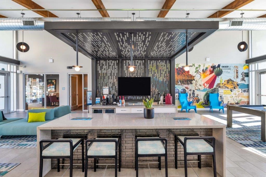 a kitchen and living room with a table and chairs